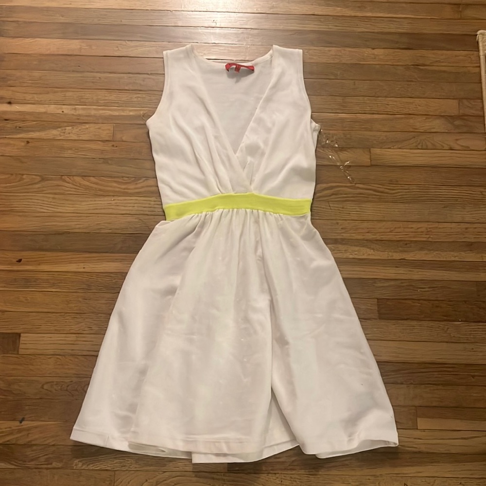 White dress with yellow around the waist